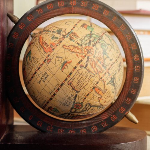 Globe and old books on the desk.